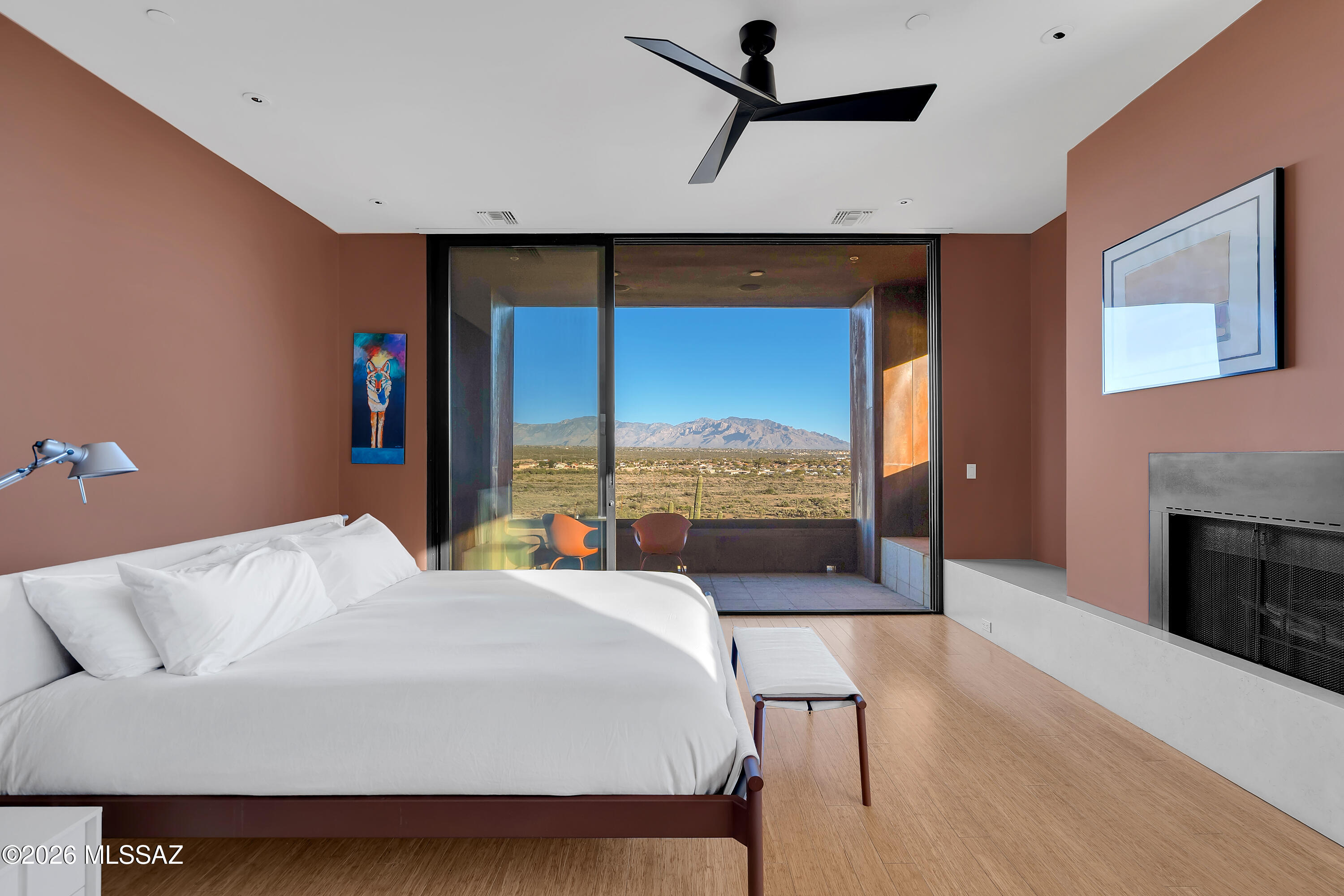 9971 North Silverbell Road Marana, AZ 85653 - Photo 14 of 34 a bedroom with a large bed and a fireplace