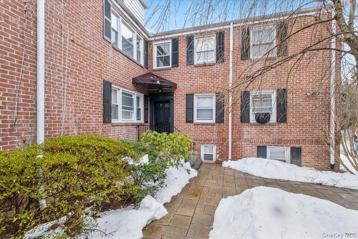 15 Chestnut Street, Unit 6A Rye, NY 10580 - Photo 1 of 27 a view of a brick building next to a yard