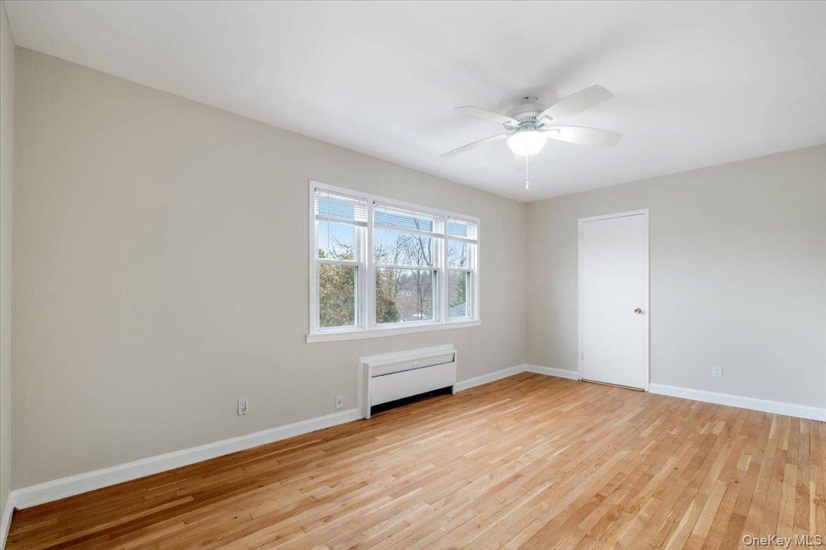 15 Chestnut Street, Unit 6A Rye, NY 10580 - Photo 17 of 27 an empty room with wooden floor and windows