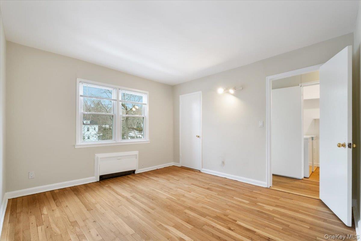 15 Chestnut Street, Unit 6A Rye, NY 10580 - Photo 19 of 27 an empty room with wooden floor and windows