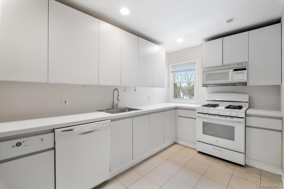 15 Chestnut Street, Unit 6A Rye, NY 10580 - Photo 3 of 27 a kitchen with granite countertop white cabinets and white appliances