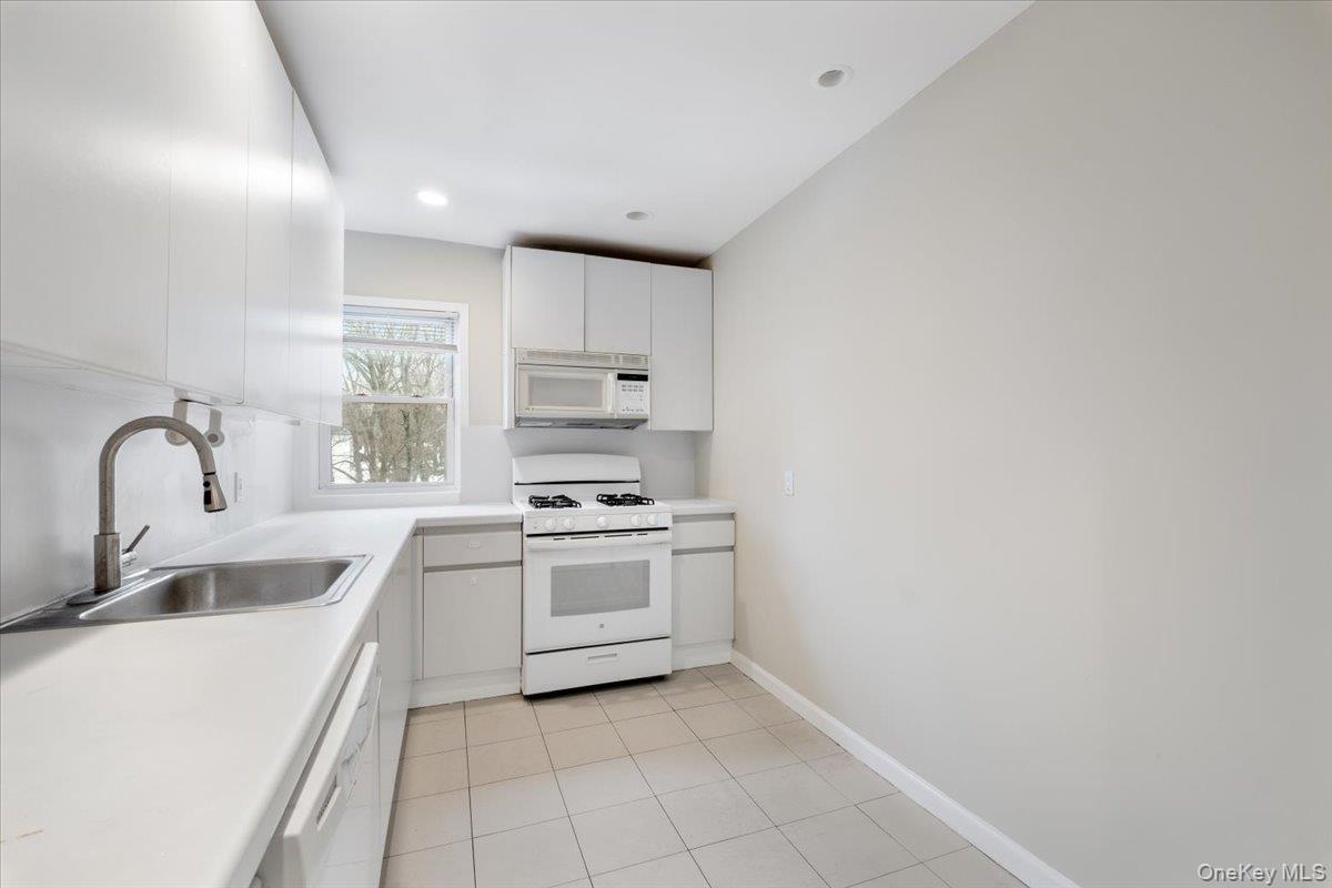 15 Chestnut Street, Unit 6A Rye, NY 10580 - Photo 4 of 27 a kitchen with a sink a stove and cabinets