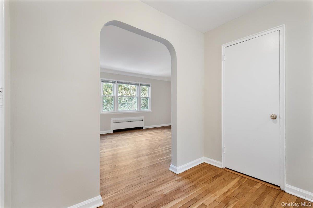 15 Chestnut Street, Unit 6A Rye, NY 10580 - Photo 5 of 27 a view of an empty room with wooden floor and a window