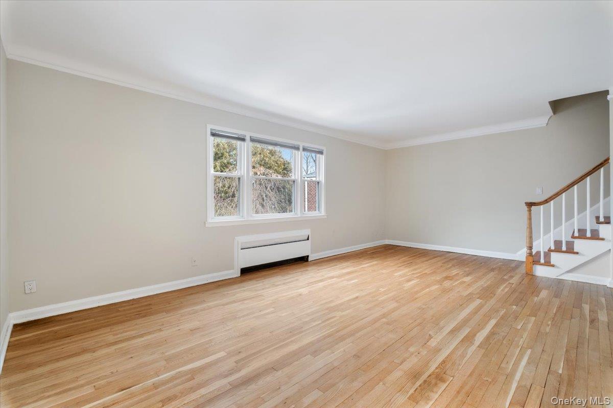 15 Chestnut Street, Unit 6A Rye, NY 10580 - Photo 7 of 27 a view of an empty room with wooden floor and a window