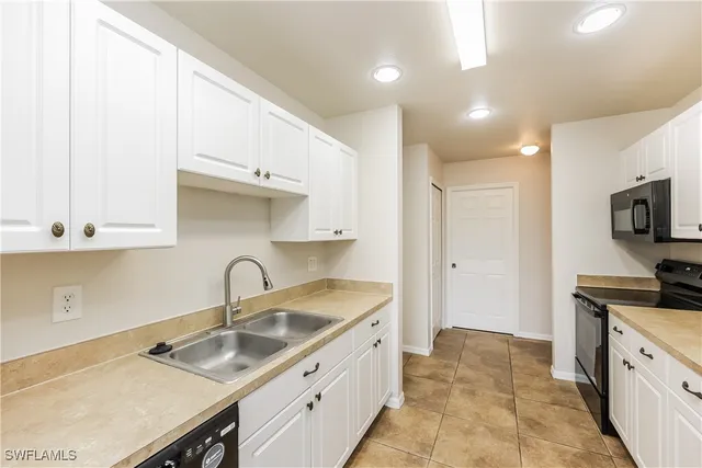 a kitchen that has a sink and a stove