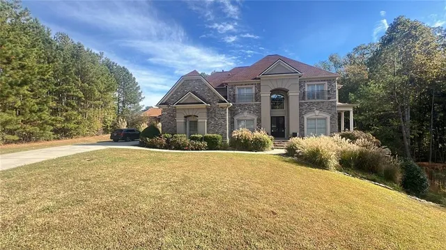 a front view of a house with a yard and garage