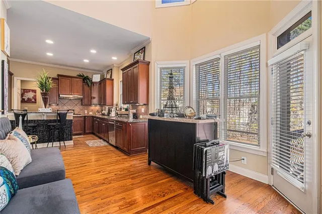 a kitchen with stainless steel appliances granite countertop a sink dishwasher and cabinets with wooden floor