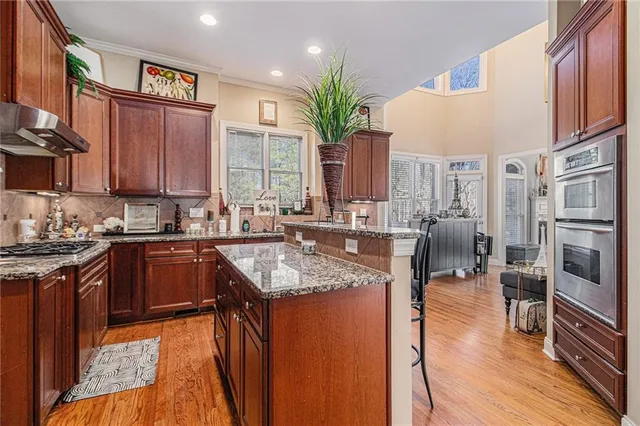 a living room with fireplace furniture and a large window