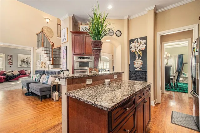 a view of a bedroom with a bed and wooden floor