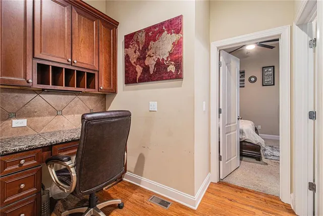 a spacious bedroom with a bed and a flat screen tv