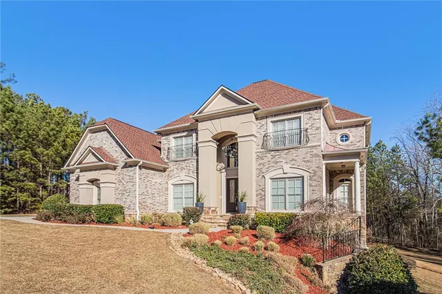 a front view of a house with a yard
