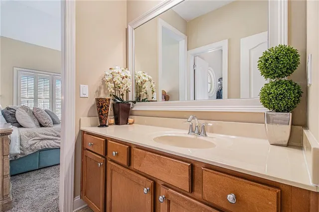 a bathroom with a sink toilet vanity and shower