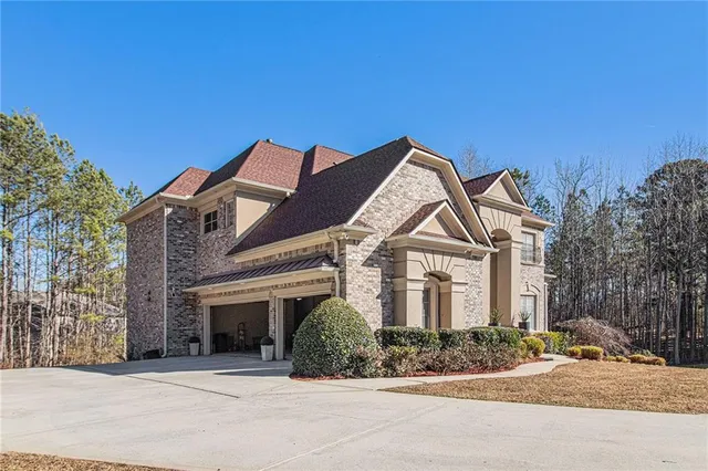 a front view of a house with a garden