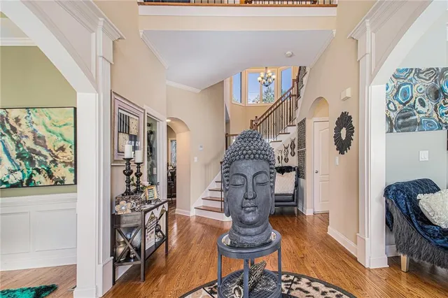 a living room with furniture kitchen view and a large window