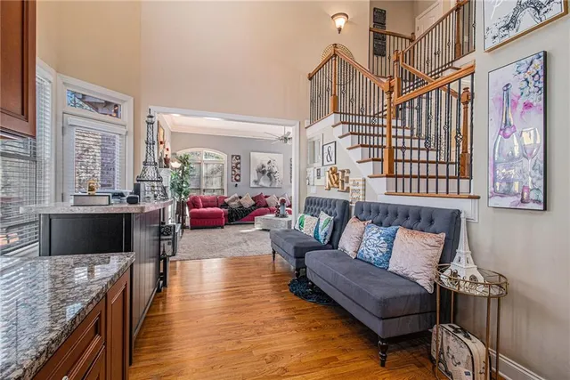 a living room with furniture a wall paintings and a window