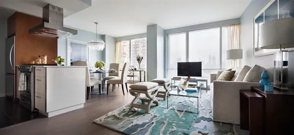 a living room with furniture a flat screen tv and a floor to ceiling window