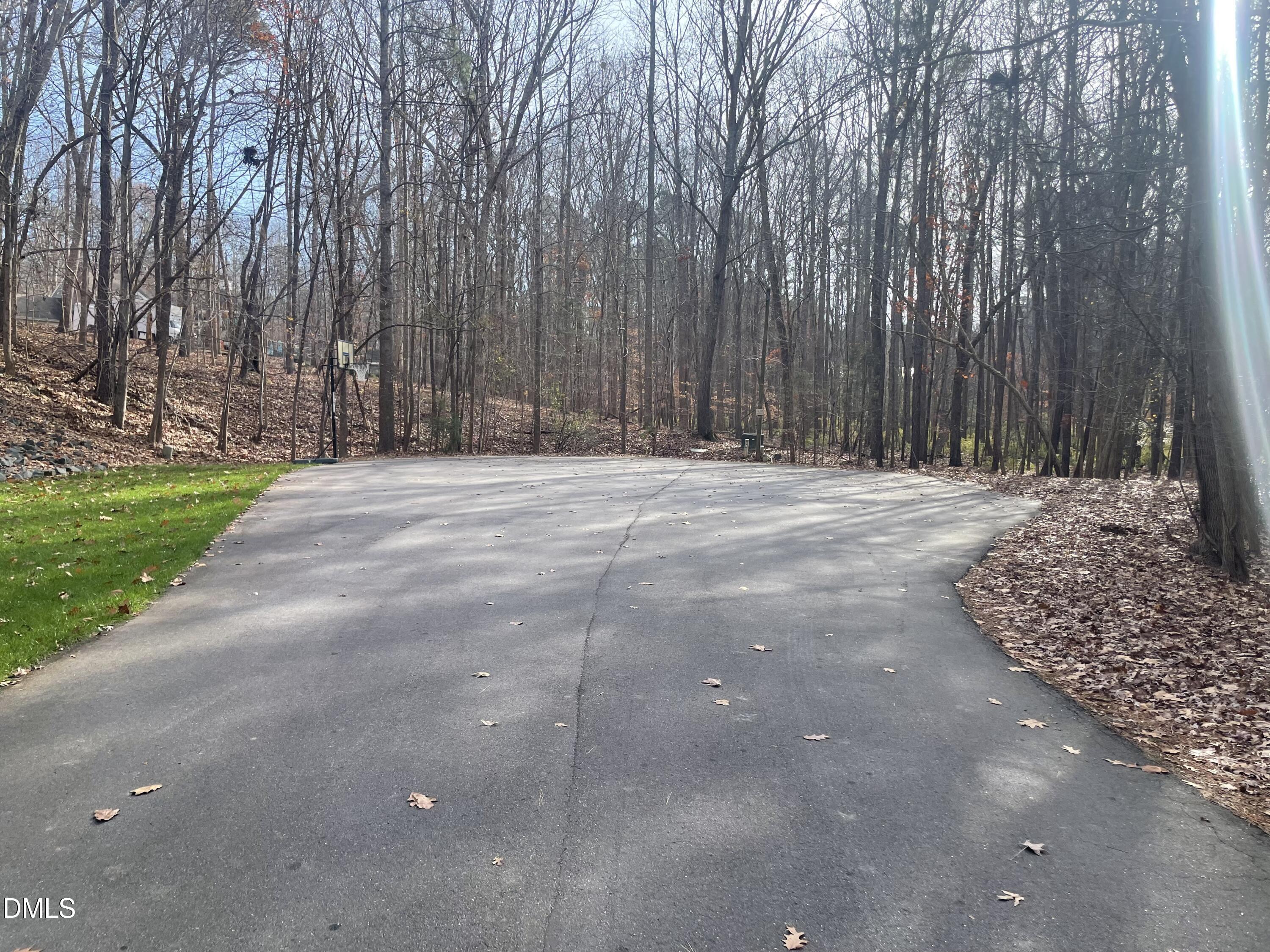 600 Hawick Road Raleigh, NC 27615 - Photo 14 of 15 a wooden bench with trees in the background