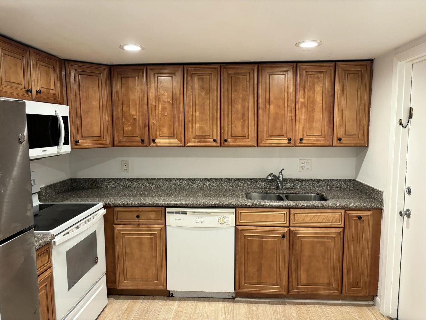 642 Northwest 13th Street, Unit 210 Boca Raton, FL 33486 - Photo 12 of 17 a kitchen with granite countertop cabinets stainless steel appliances and a sink