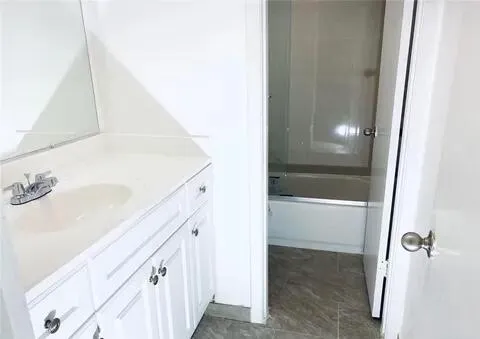a bathroom with a bathtub and a sink