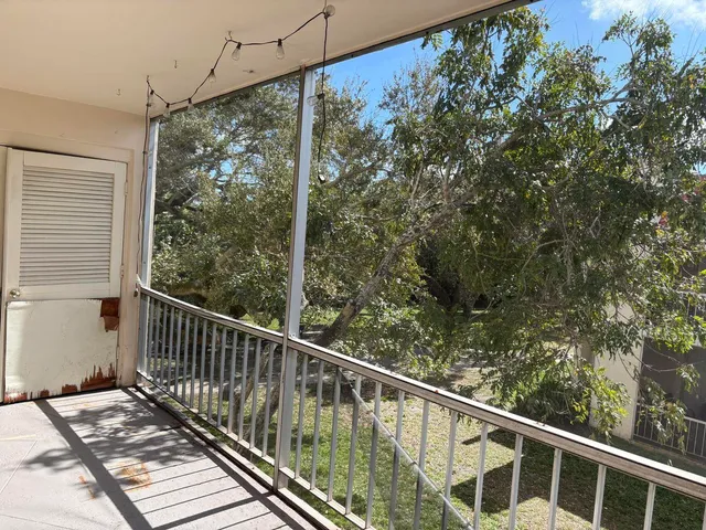 a view of a balcony with wooden floor