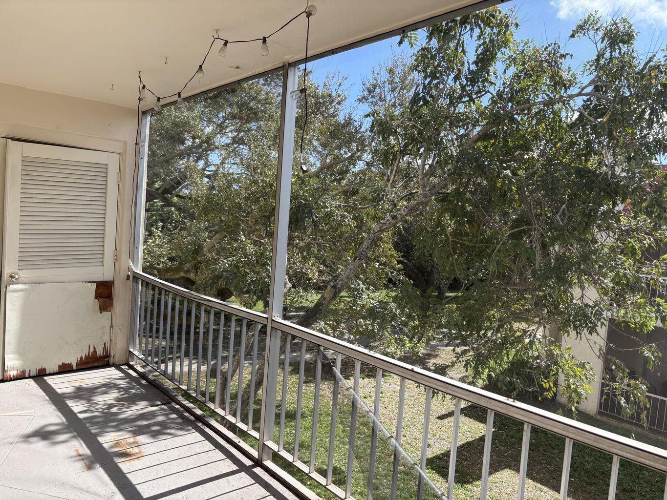 642 Northwest 13th Street, Unit 210 Boca Raton, FL 33486 - Photo 5 of 17 a view of a balcony with wooden floor