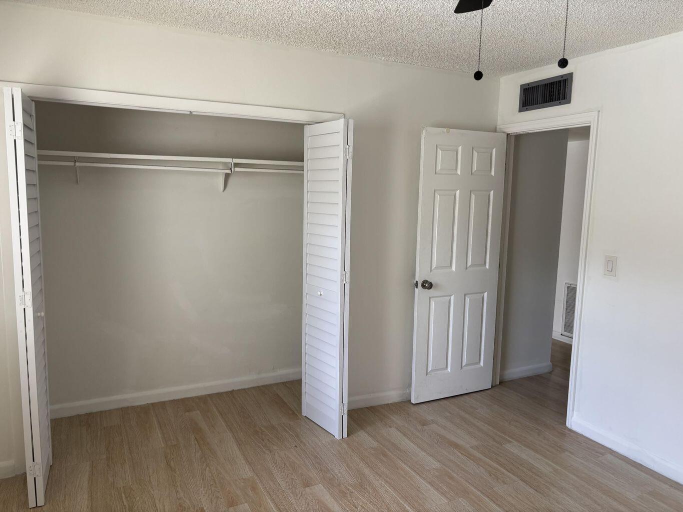 642 Northwest 13th Street, Unit 210 Boca Raton, FL 33486 - Photo 9 of 17 a view of an empty room with wooden floor