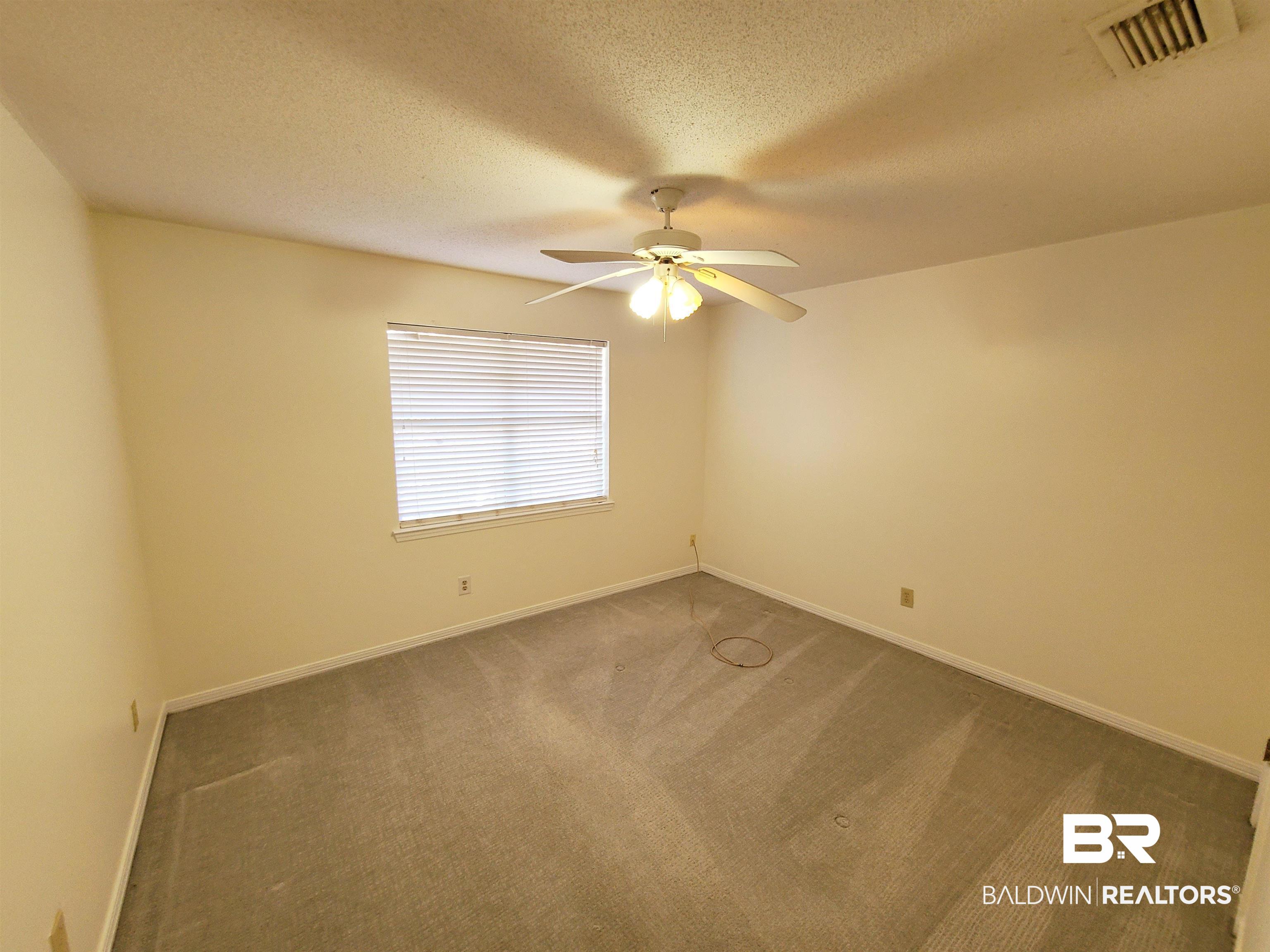 123 Melanie Loop Daphne, AL 36526 - Photo 14 of 17 Carpeted empty room featuring a textured ceiling and a ceiling fan