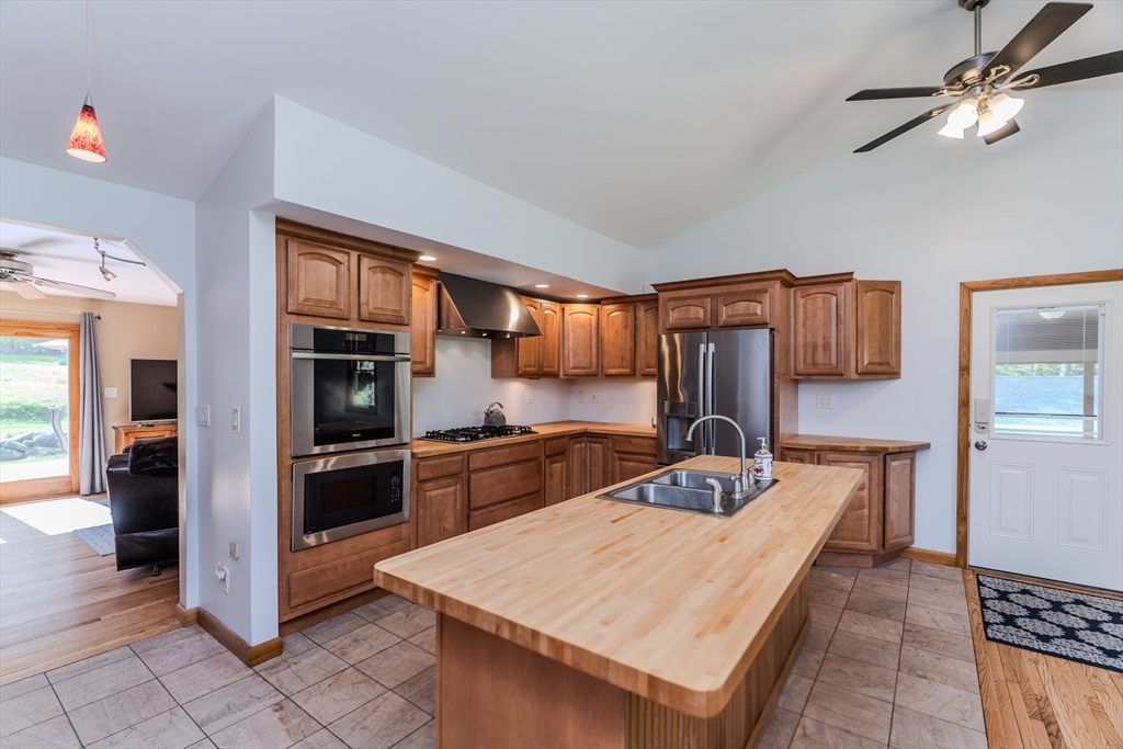 48 Ames Road Hampden, MA 01036 - Photo 26 of 42 a kitchen with stainless steel appliances granite countertop a stove refrigerator sink and cabinets