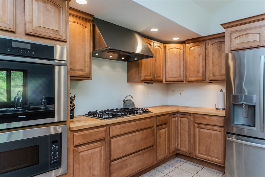 48 Ames Road Hampden, MA 01036 - Photo 27 of 42 a kitchen with stainless steel appliances granite countertop a stove a sink and a refrigerator