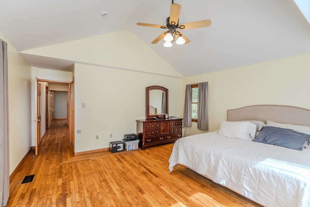 48 Ames Road Hampden, MA 01036 - Photo 34 of 42 a bedroom with a bed and a chandelier
