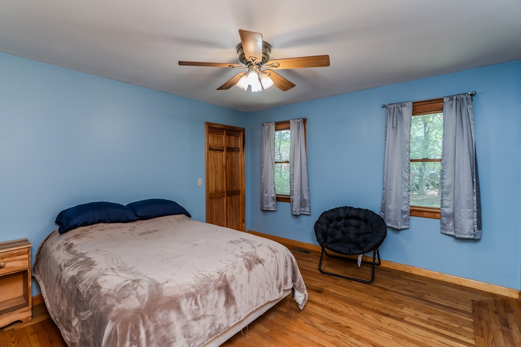 48 Ames Road Hampden, MA 01036 - Photo 36 of 42 a bedroom with a bed and a chandelier