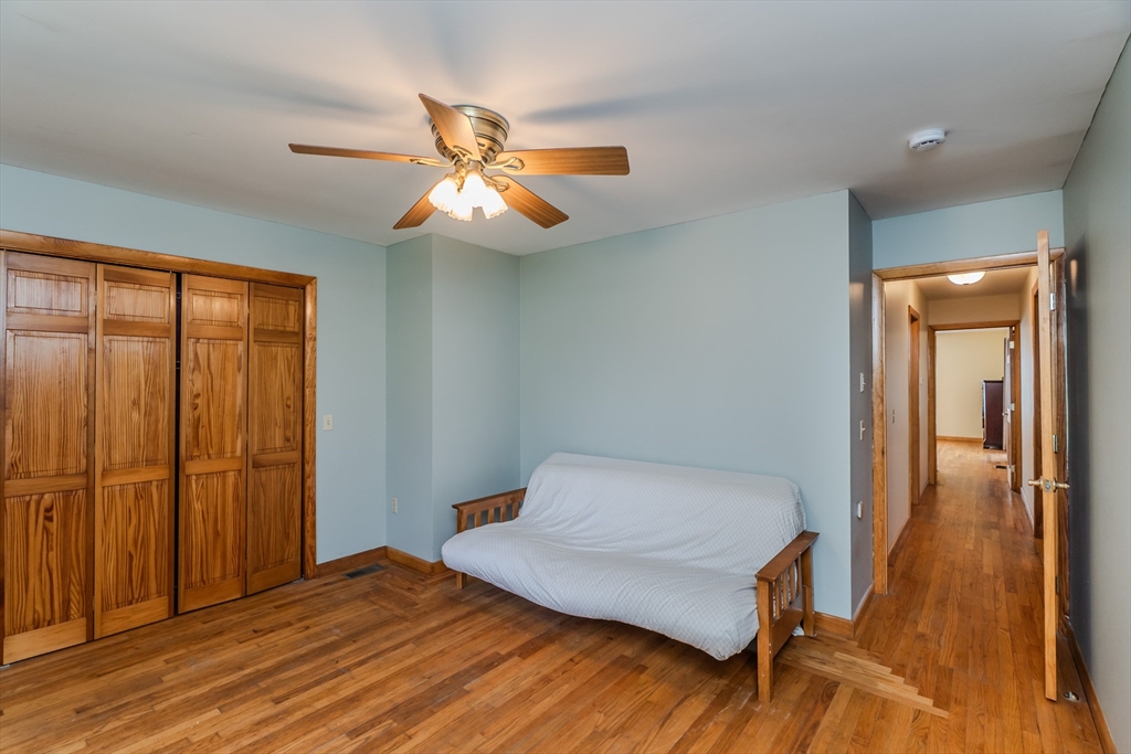 48 Ames Road Hampden, MA 01036 - Photo 39 of 42 a bedroom with a bed and wooden floor