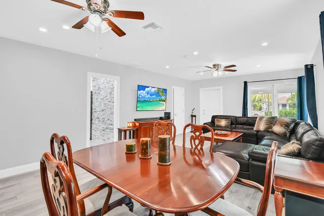 a dining room with furniture a window and wooden floor