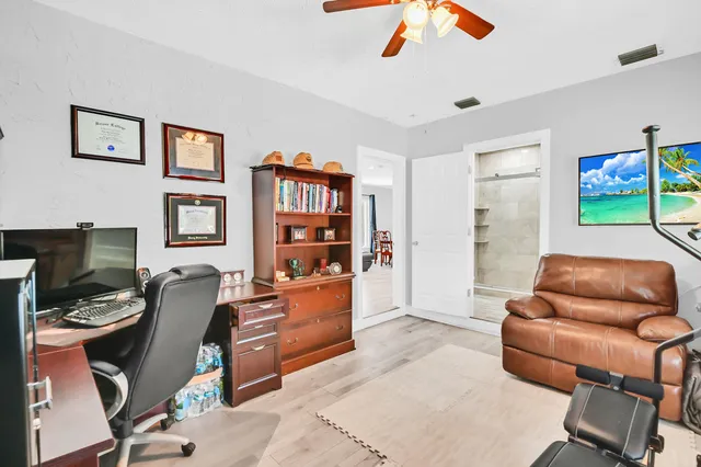 a work room with furniture and book shelfs