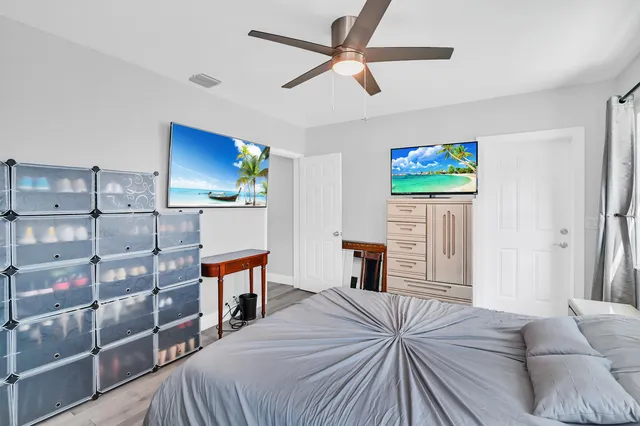 a bedroom with a bed and a flat screen tv
