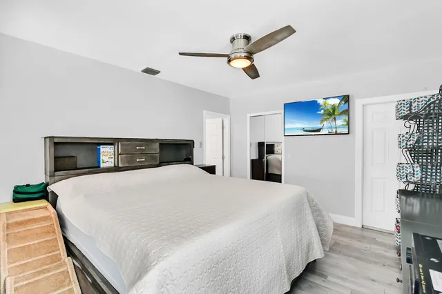 a bedroom with a bed and a tv