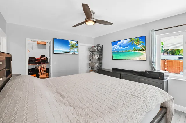 a bedroom with a bed and a flat screen tv
