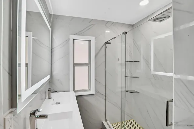 a bathroom with a bathtub and a shower