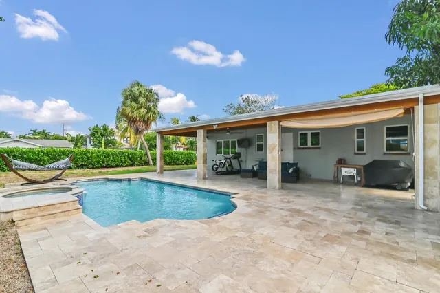 a view of a house with backyard porch and sitting area