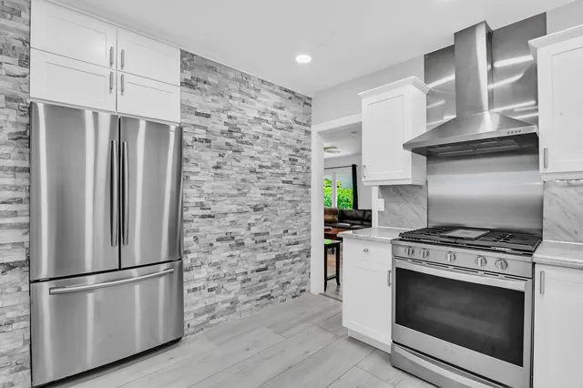 a kitchen with stainless steel appliances and a refrigerator