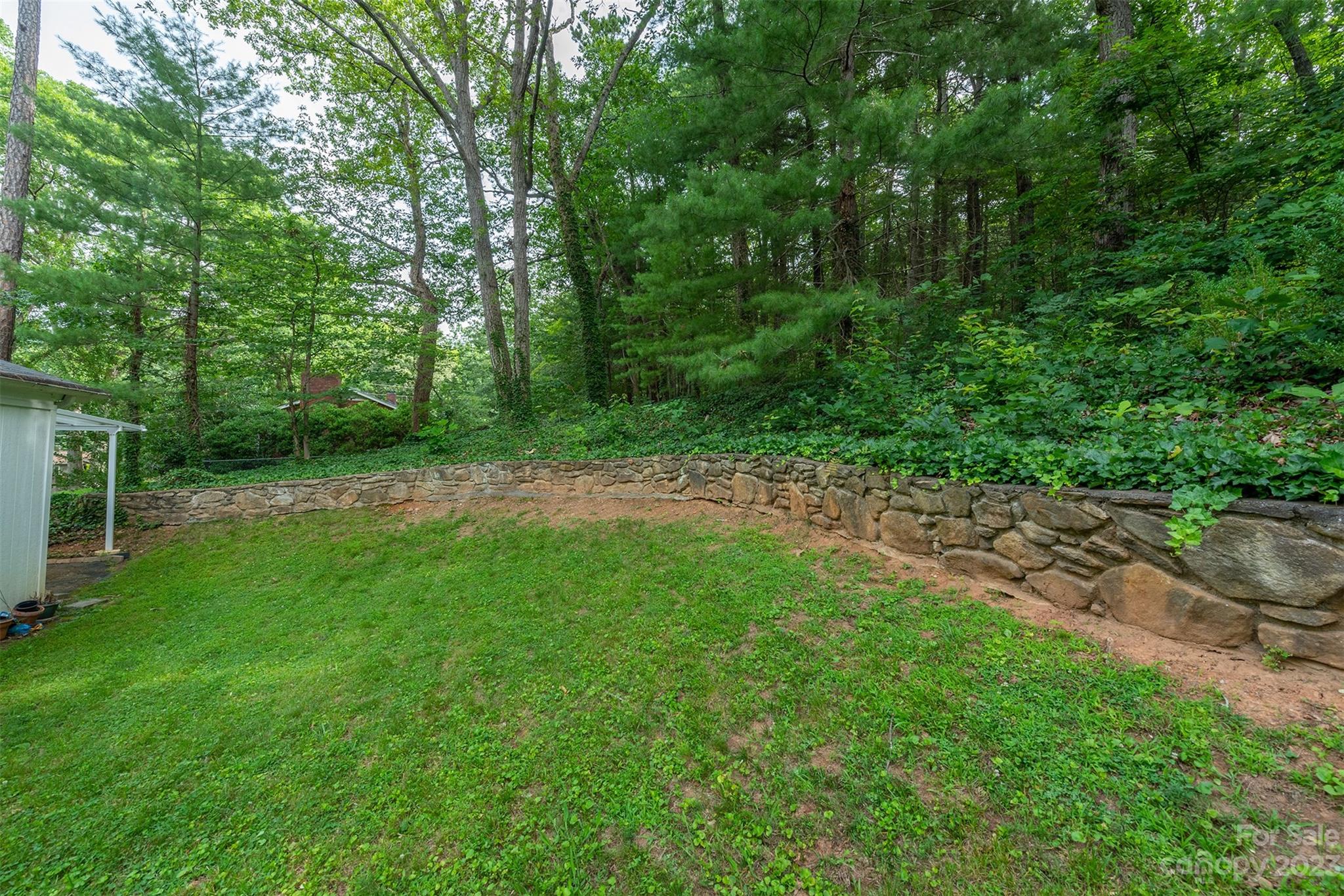 92 Alpine Way Asheville, NC 28805 - Photo 19 of 22 a view of a grassy field with trees in the background