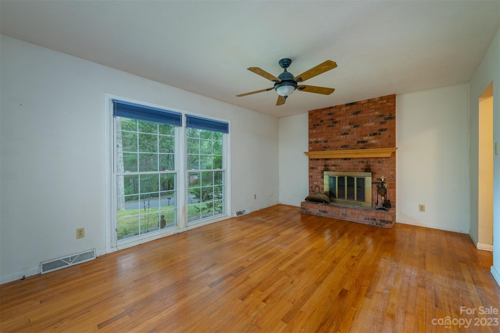 92 Alpine Way Asheville, NC 28805 - Photo 3 of 22 a view of empty room with wooden floor and fan