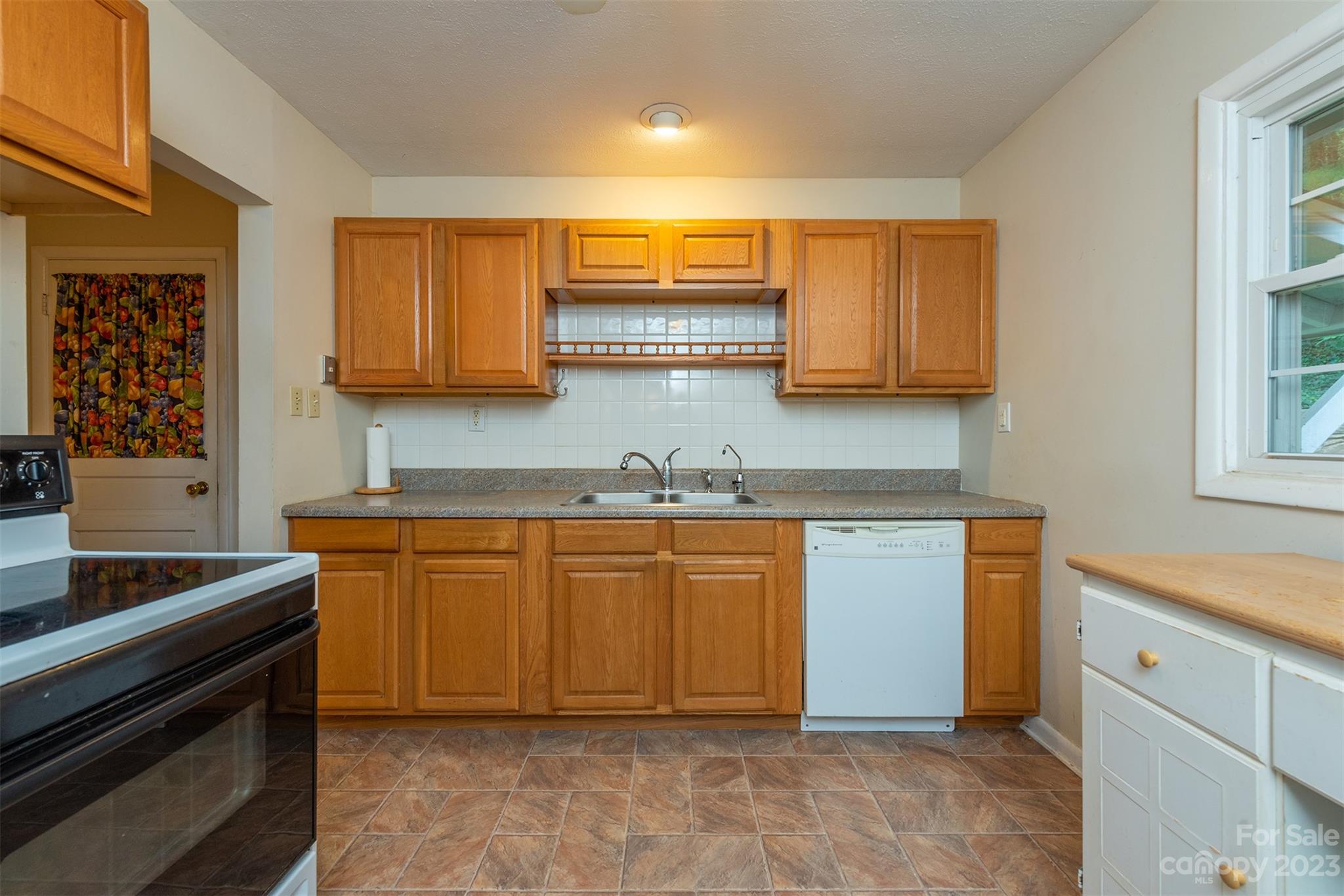 92 Alpine Way Asheville, NC 28805 - Photo 6 of 22 a kitchen with stainless steel appliances granite countertop a stove a sink and a microwave