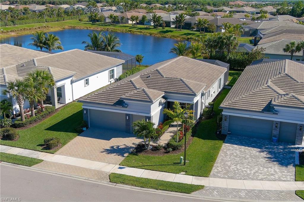 an aerial view of a house with garden space and lake view