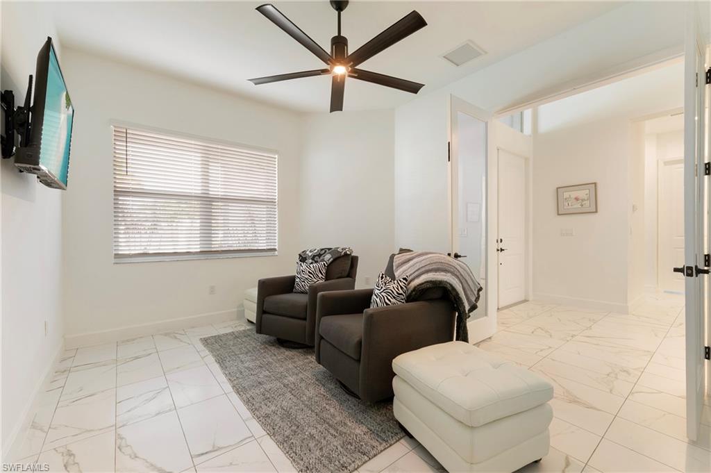 11488 Coronado Way Naples, FL 34120 - Photo 20 of 50 a living room with furniture a ceiling fan and a window