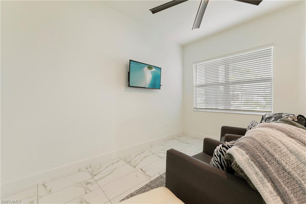 11488 Coronado Way Naples, FL 34120 - Photo 21 of 50 a bedroom with a bed and a window