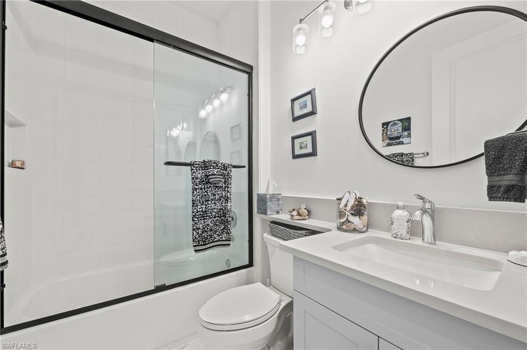 11488 Coronado Way Naples, FL 34120 - Photo 28 of 50 a bathroom with a sink a toilet and a mirror