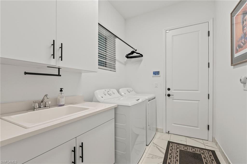 11488 Coronado Way Naples, FL 34120 - Photo 30 of 50 a bathroom with a sink and mirror