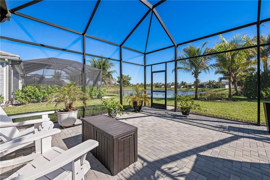 11488 Coronado Way Naples, FL 34120 - Photo 37 of 50 a view of a patio with a table and chairs under an umbrella