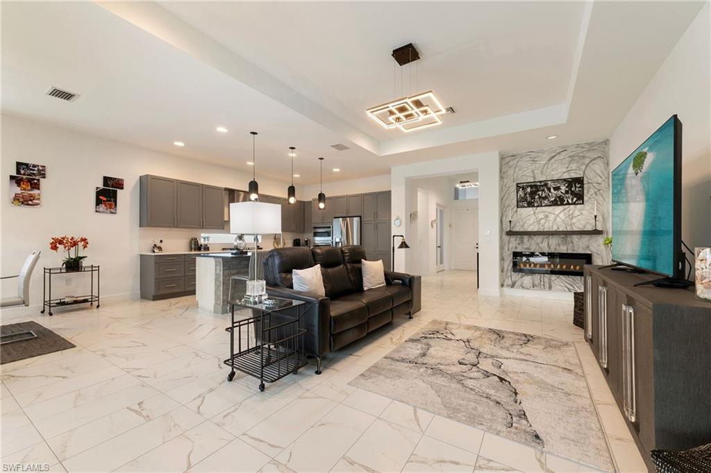 11488 Coronado Way Naples, FL 34120 - Photo 4 of 50 a living room with furniture and a flat screen tv